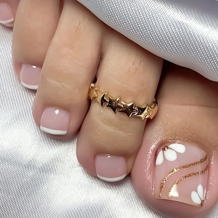 French tip pedicure with floral gold nail art and toe ring